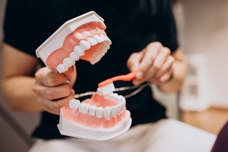 Demonstration of proper tooth brushing technique using dental model for oral hygiene education